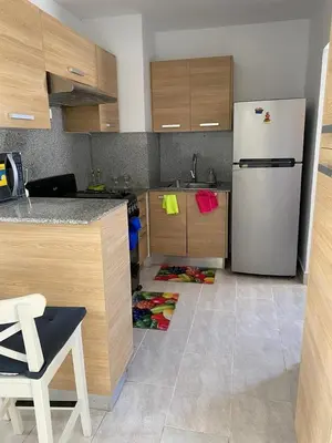 a kitchen with a refrigerator and a floor with shoes at Apartment in Riviera Colonial in Calero