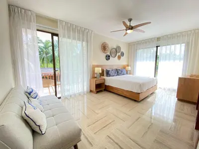 a bedroom with a bed and a couch at Charming two-bedroom apartment in Las Terrenas in Las Terrenas