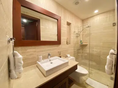 a bathroom with a sink and a toilet and a mirror at Charming two-bedroom apartment in Las Terrenas in Las Terrenas