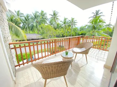 a balcony with two chairs and a table at Charming two-bedroom apartment in Las Terrenas in Las Terrenas