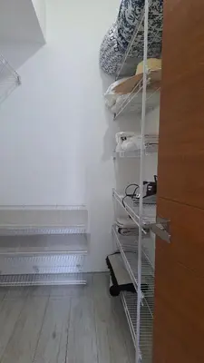 a room with a closet with shelves and stairs at Two-Bedroom Apartment in Santo Domingo in Santo Domingo
