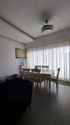 a living room with a table and chairs and a couch at Two-Bedroom Apartment in Santo Domingo in Santo Domingo