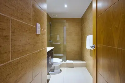 a bathroom with a toilet and a sink at Escape Beachfront Condos Las Olas Juan Dolio in La Puntica de Juan Dolio