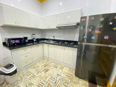 a kitchen with white cabinets and a stainless steel refrigerator at Colonial zone 3 bed 3 rooms balcony in Santo Domingo
