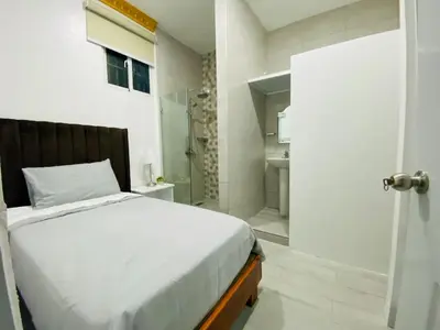 a bedroom with a bed and a walk in shower at Colonial zone 3 bed 3 rooms balcony in Santo Domingo