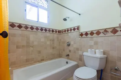 a bathroom with a tub and a toilet and a sink at Oceanfront Apartment in Cabarete with Pool and Beach Access in Cabarete
