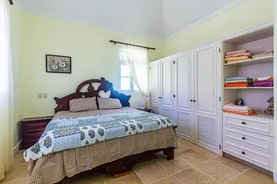 a bedroom with a bed in a room with shelves at Oceanfront Apartment in Cabarete with Pool and Beach Access in Cabarete