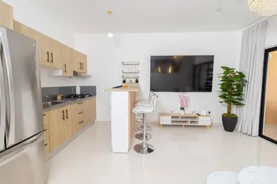 a kitchen with a refrigerator and a white floor at Serene 2-Bedroom Coastal Retreat in Bayahibe in San Rafael del Yuma