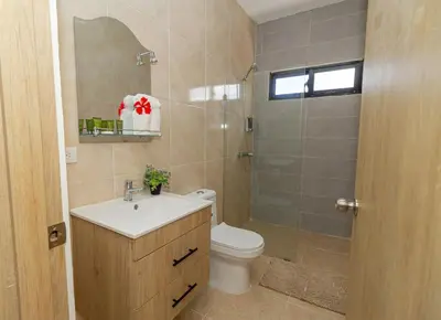 a bathroom with a toilet and a sink and a shower at Serene 2-Bedroom Coastal Retreat in Bayahibe in San Rafael del Yuma