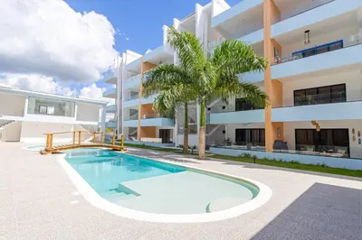 a swimming pool in front of a building at Serene 2-Bedroom Coastal Retreat in Bayahibe in San Rafael del Yuma