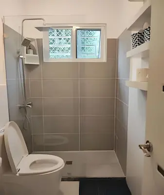 a bathroom with a toilet and a shower at Bayahibe Rose C - Gray Elegance in San Rafael del Yuma
