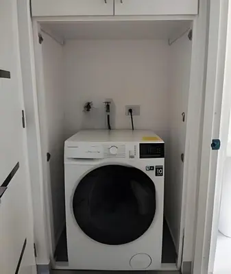 a washer and dryer in a small room at Bayahibe Rose C - Gray Elegance in San Rafael del Yuma