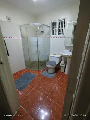 a bathroom with a shower and a toilet and a sink at Residencial Oasis in Juan López