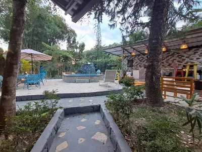 a patio with a table and chairs and a fountain at Villa la casita in Villa Altagracia
