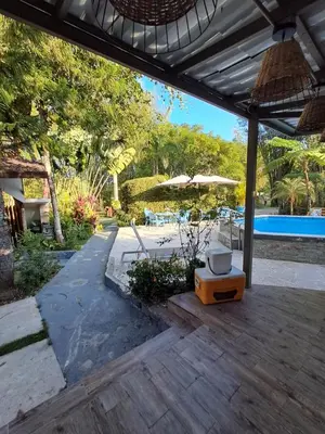 a patio with an umbrella and a swimming pool at Villa la casita in Villa Altagracia