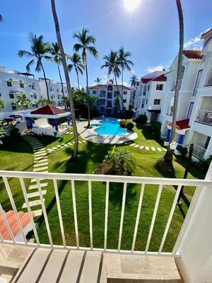 a view of the pool from the balcony of a resort at Fantástico Lugar en el Centro de los Corales RD in Punta Cana