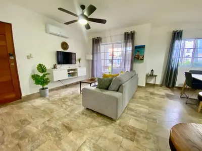 a living room with a couch and a ceiling fan at Fantástico Lugar en el Centro de los Corales RD in Punta Cana