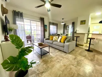 a living room with a couch and a ceiling fan at Fantástico Lugar en el Centro de los Corales RD in Punta Cana
