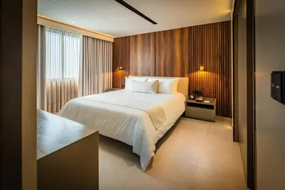 a hotel room with a bed and a window at Nohian Collection Hotels in Santiago de los Caballeros