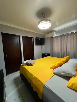 a bedroom with two beds with yellow sheets at Apartamento amueblado in Arenoso