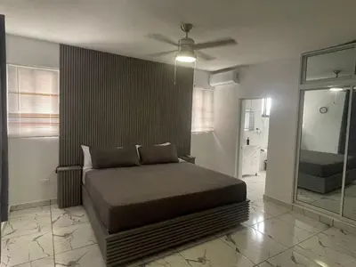 a bedroom with a bed and a ceiling fan at Level Suites 3 Premium Suite in Sosúa