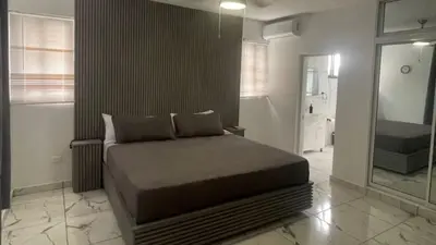 a bedroom with a bed and a large mirror at Level Suites 3 Premium Suite in Sosúa