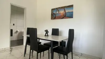 a dining room table with black chairs and a picture on the wall at Level Suites 3 Premium Suite in Sosúa