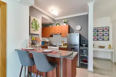 a kitchen with a counter and a refrigerator at Gorgeous Banana Places QDA-IV in Santo Domingo