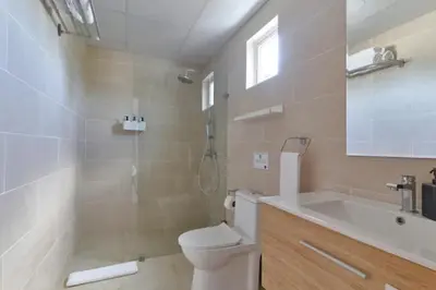 a bathroom with a toilet and a shower and a sink at Gorgeous Banana Places QDA-IV in Santo Domingo