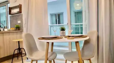 a table and chairs in a kitchen with a window at Natural Boho Places QDA-III in Santo Domingo