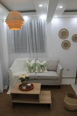 a living room with a couch and butterfly pillows at Cozy Apt with Puerto Plata view in San Felipe de Puerto Plata