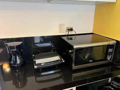 a microwave sitting on top of a kitchen counter at Garden House in Las Galeras