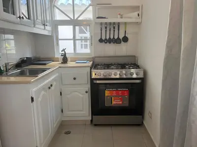 a kitchen with a stove and a sink at Cozy Condo - 4 min to the Beach in Punta Cana