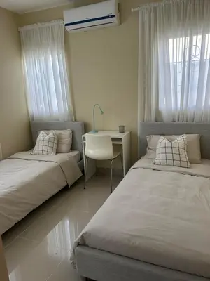 a bedroom with two beds and a desk and a table at Villa Atlantica Punta Cana in Punta Cana