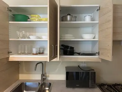 a kitchen with a sink and a microwave at Villa Atlantica Punta Cana in Punta Cana