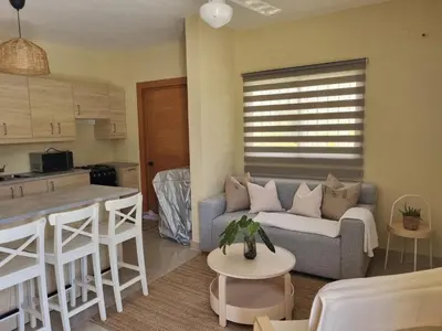 a living room with a couch and a kitchen at Villa Atlantica Punta Cana in Punta Cana