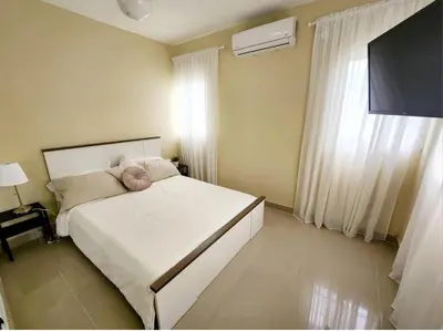 a bedroom with a white bed and a window at Villa Atlantica Punta Cana in Punta Cana