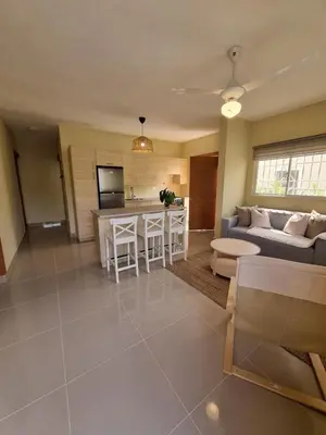a living room with a couch and a table at Villa Atlantica Punta Cana in Punta Cana