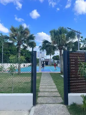 a gate with two palm trees in a park at Lux 3BR Oasis With Gazebo & Pool in Pontezuela Arriba