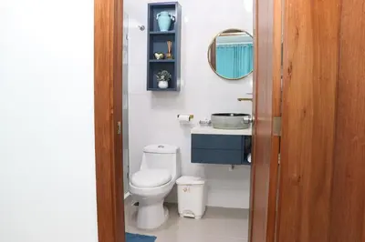 a bathroom with a toilet and a sink and a mirror at Lux 3BR Oasis With Gazebo & Pool in Pontezuela Arriba