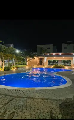 a large blue swimming pool at night at Lux 3BR Oasis With Gazebo & Pool in Pontezuela Arriba