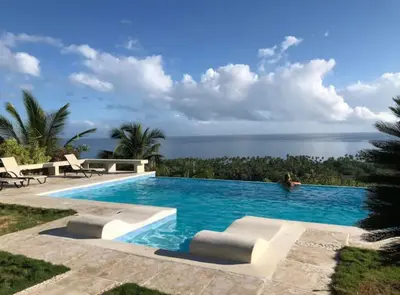 a swimming pool with a view of the ocean at Villa with Stunning Ocean View, Infinity pool in Las Terrenas