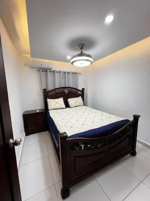 a bedroom with a bed in a room at Apartamento O3 Palma Real in Santiago de los Caballeros
