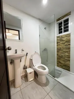 a bathroom with a toilet and a sink and a shower at Apartamento O3 Palma Real in Santiago de los Caballeros