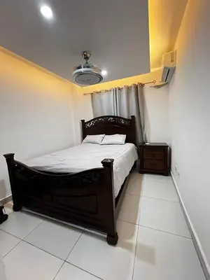 a bedroom with a bed with a white floor at Apartamento O3 Palma Real in Santiago de los Caballeros