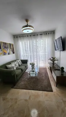 a living room with a green couch and a glass table at vista hermosa in Cabrera