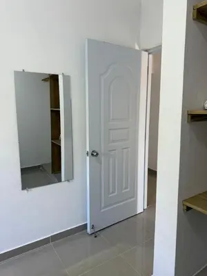 a white door with a mirror in a room at Apartamento Media Luna in Cabrera