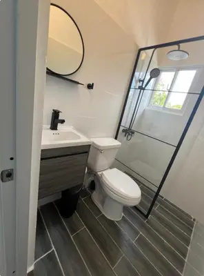 a bathroom with a toilet and a sink and a shower at Apartamento Media Luna in Cabrera