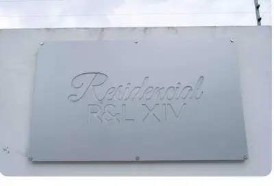 a sign for a restaurant on the side of a building at Exclusive Luxury Apartment with Pool in Santiago de los Caballeros