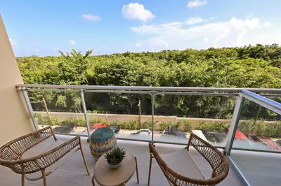 a balcony with two chairs and a table on a balcony at 404 y 504 Luxurious PH with Jacuzzi near the Beach in La Laguna